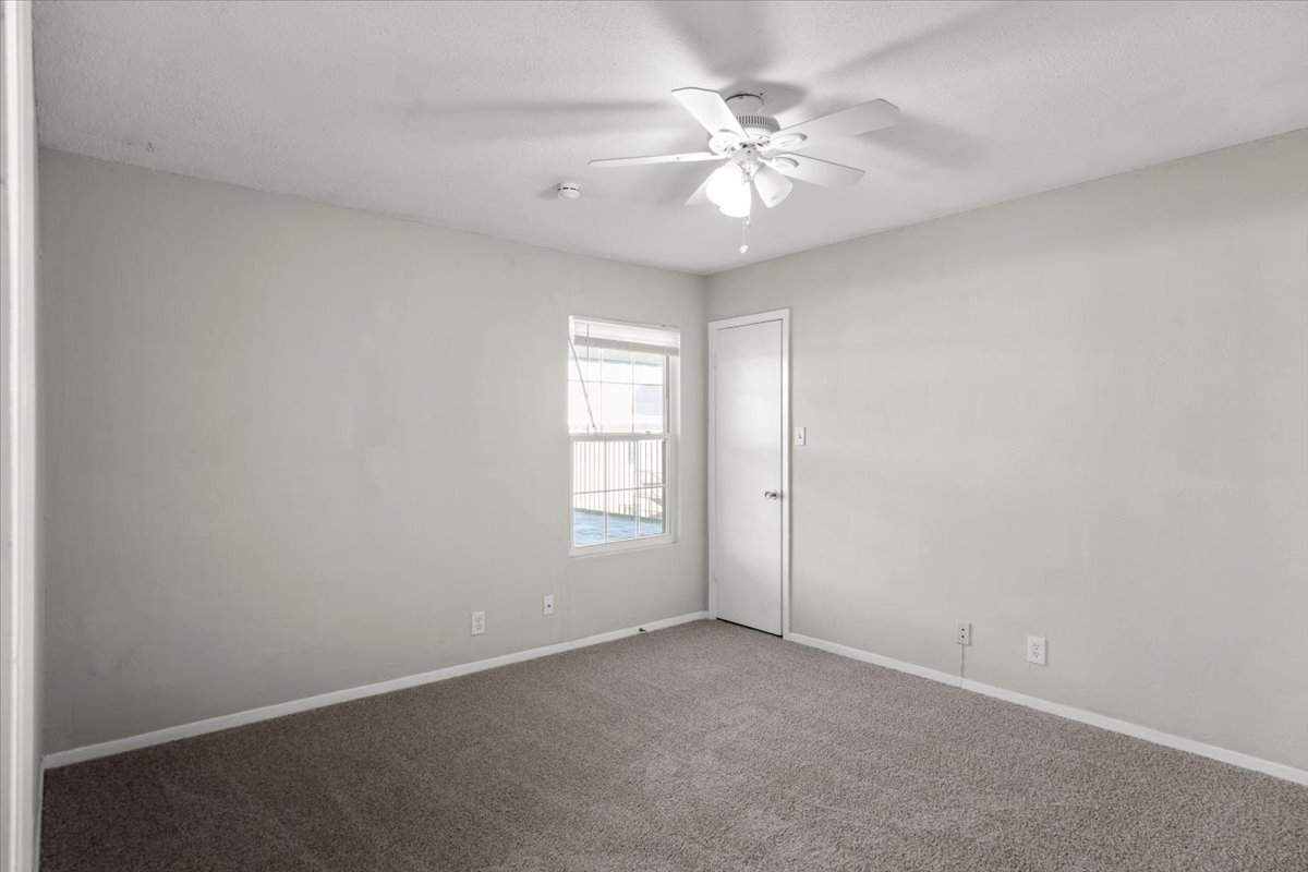 910 Duncan Lane, Unit 57 Austin, TX 78705 - Photo 17 of 34 an empty room with windows and fan
