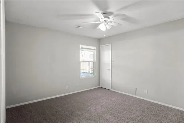 an empty room with windows and cabinet