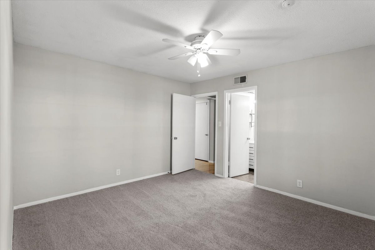 910 Duncan Lane, Unit 57 Austin, TX 78705 - Photo 19 of 34 an empty room with a fan and a fan