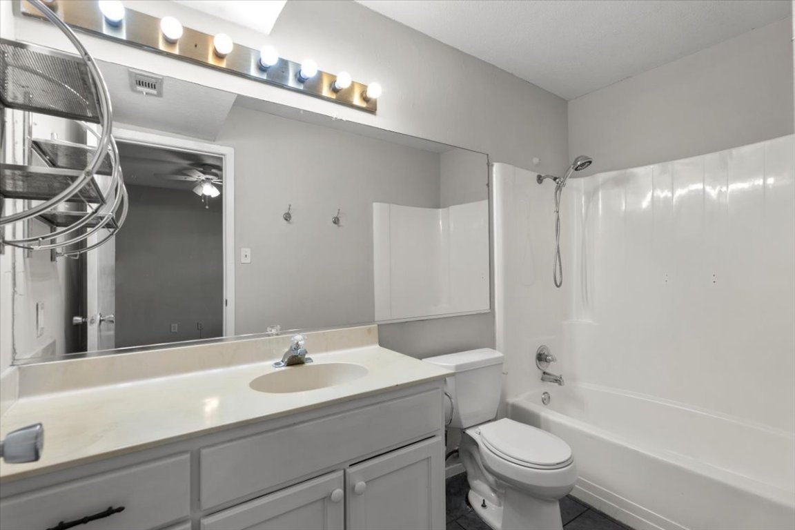 910 Duncan Lane, Unit 57 Austin, TX 78705 - Photo 21 of 34 a bathroom with a sink a toilet and shower
