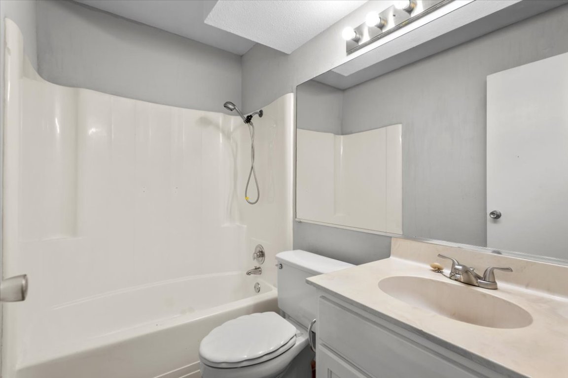910 Duncan Lane, Unit 57 Austin, TX 78705 - Photo 27 of 34 a bathroom with a sink toilet vanity and shower
