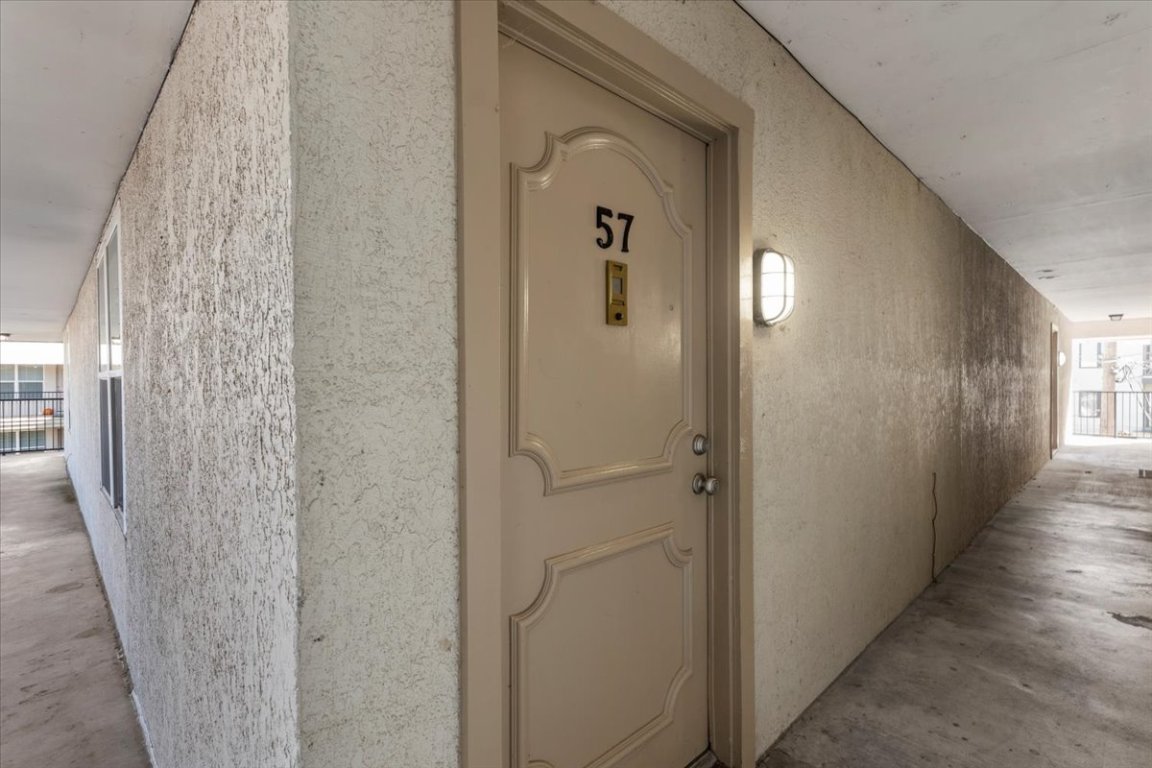 910 Duncan Lane, Unit 57 Austin, TX 78705 - Photo 3 of 34 a view of a hallway with wooden floor and closet area