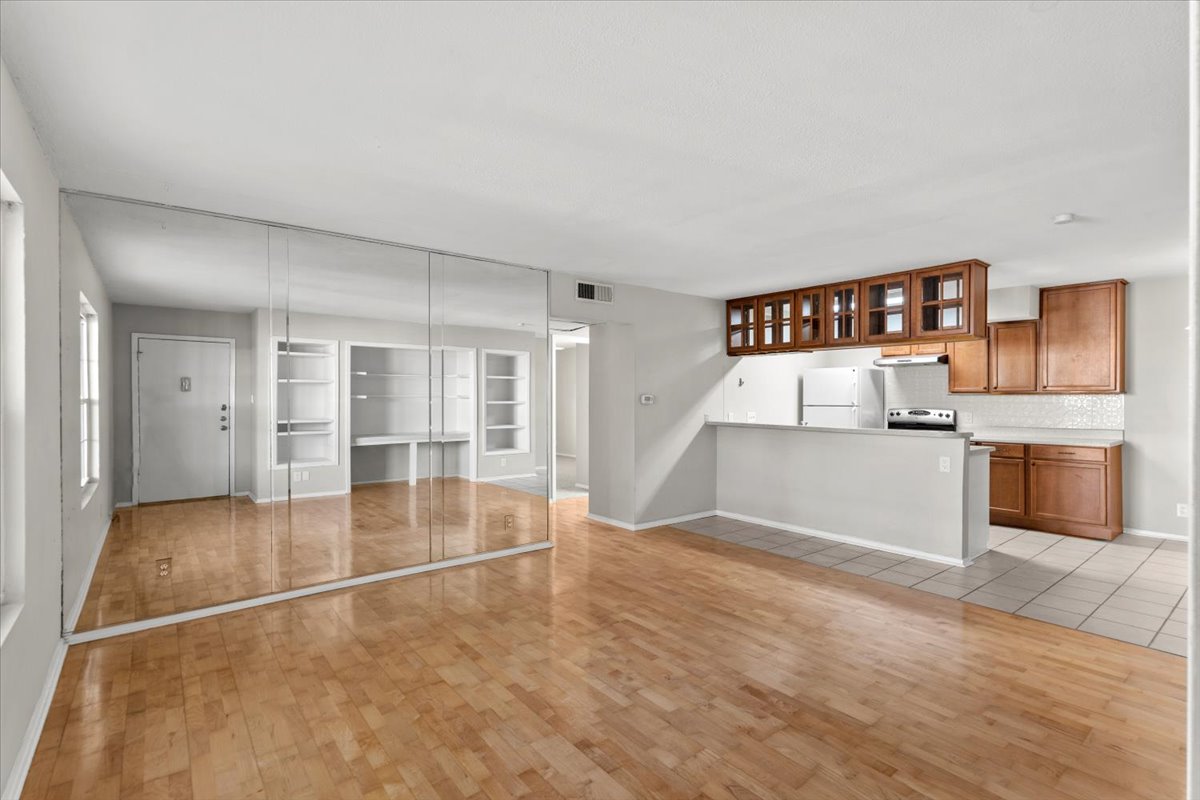 910 Duncan Lane, Unit 57 Austin, TX 78705 - Photo 4 of 34 a view of a kitchen with a sink and a refrigerator
