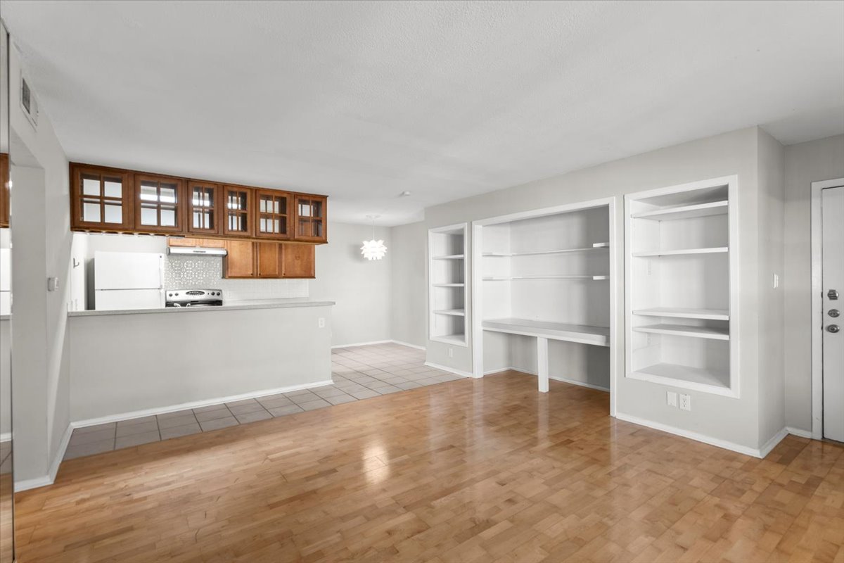 910 Duncan Lane, Unit 57 Austin, TX 78705 - Photo 5 of 34 a view of a kitchen with wooden cabinet and a window