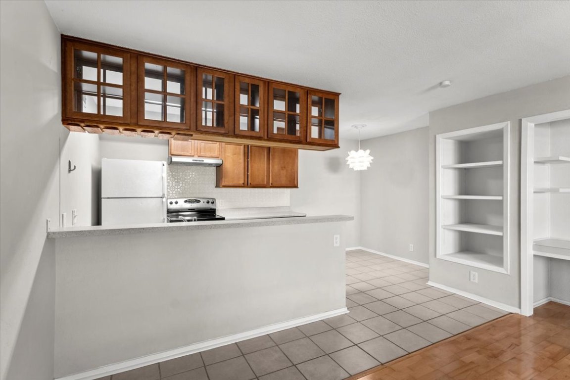 910 Duncan Lane, Unit 57 Austin, TX 78705 - Photo 9 of 34 a kitchen with a sink and cabinets