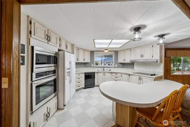 a kitchen with sink cabinets and window