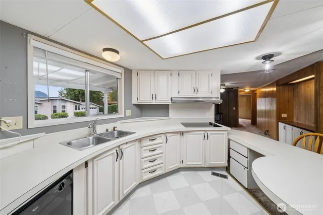 a kitchen with white cabinets and white appliances