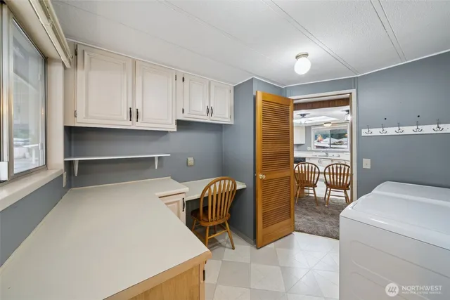 a utility room with closet dryer and washer