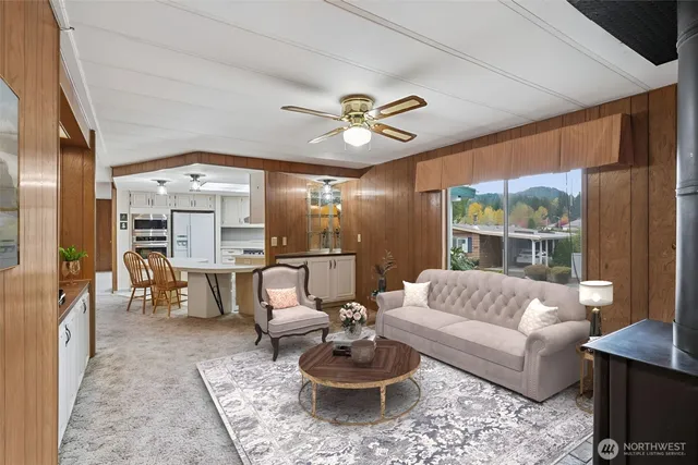 a view of a livingroom with furniture and chandelier fan