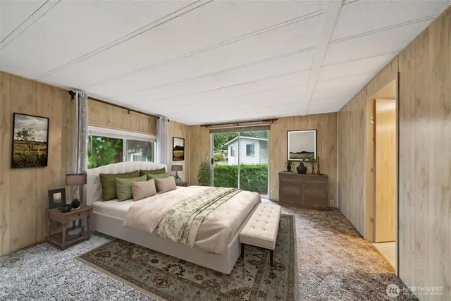 a view of an empty room with window and closet area