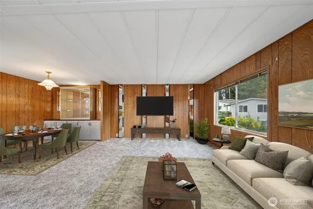 a living room with furniture and large windows