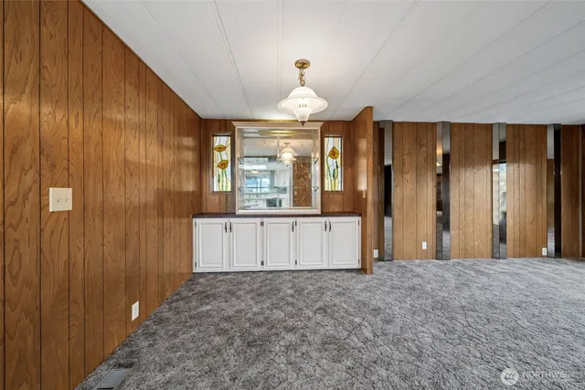 a kitchen with stainless steel appliances a sink a stove a chimney a refrigerator and cabinets