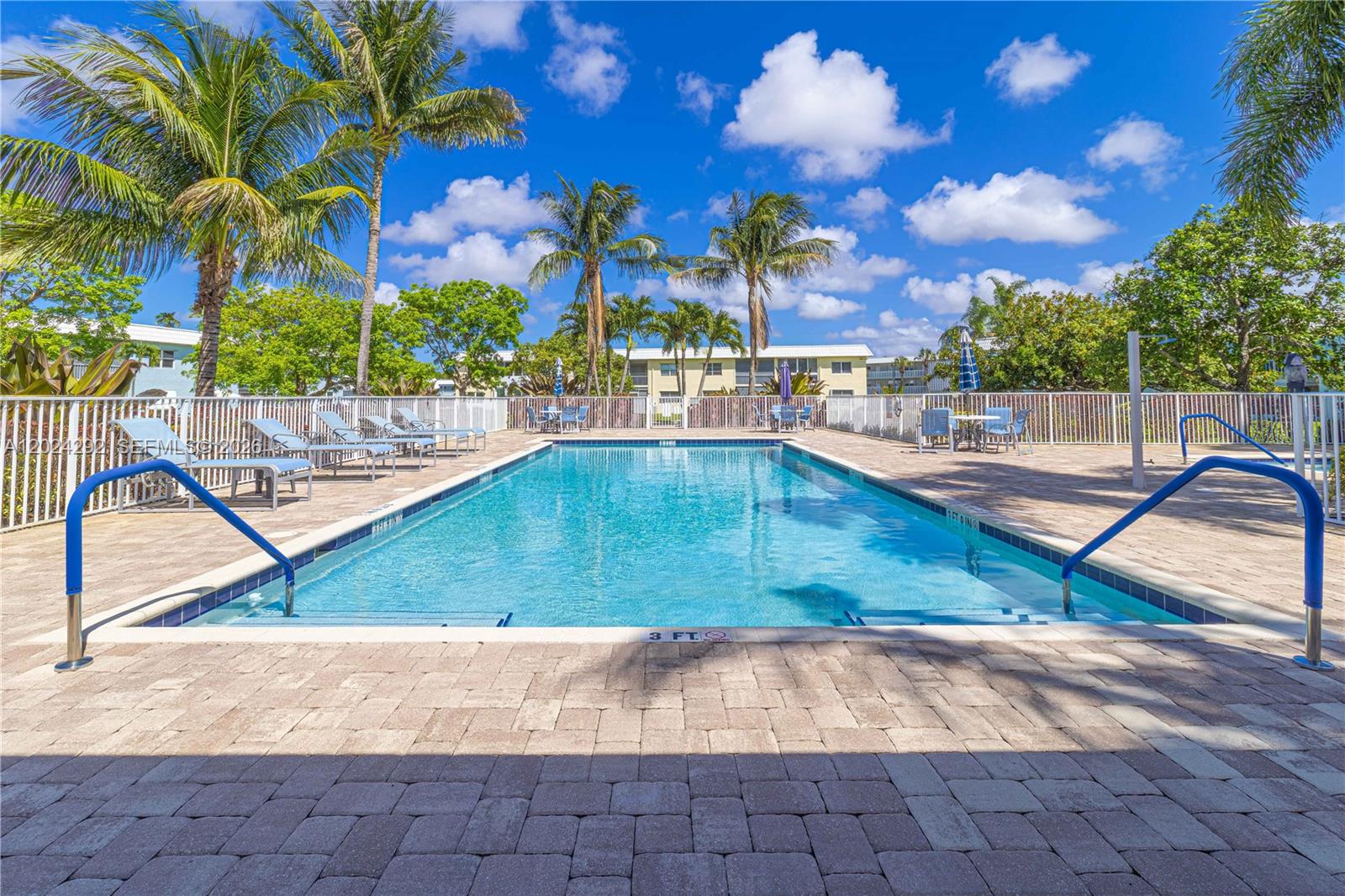 9780 Marina Boulevard, Unit 424 Boca Raton, FL 33428 - Photo 29 of 32 a view of a swimming pool with a patio