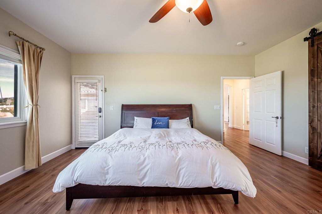 30606 Falling Star Circle Valley Center, CA 92082 - Photo 12 of 70 a bedroom with a bed and wooden floor