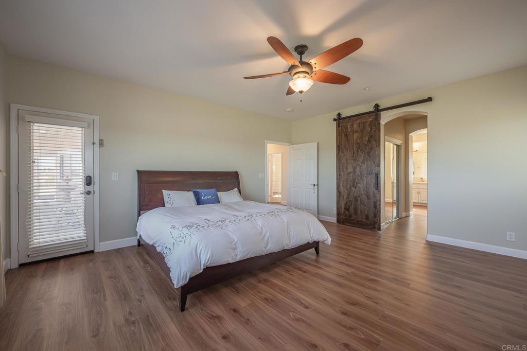 30606 Falling Star Circle Valley Center, CA 92082 - Photo 13 of 70 a bedroom with a bed and a chandelier