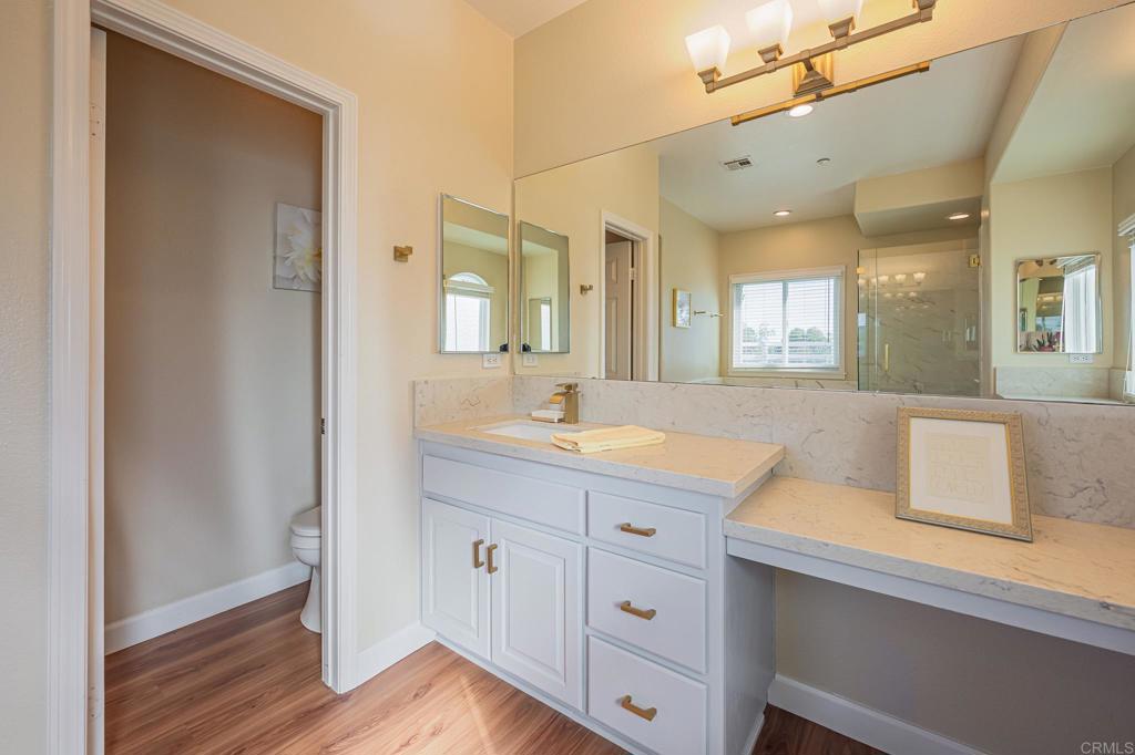 30606 Falling Star Circle Valley Center, CA 92082 - Photo 17 of 70 a spacious bathroom with a granite countertop sink mirror and