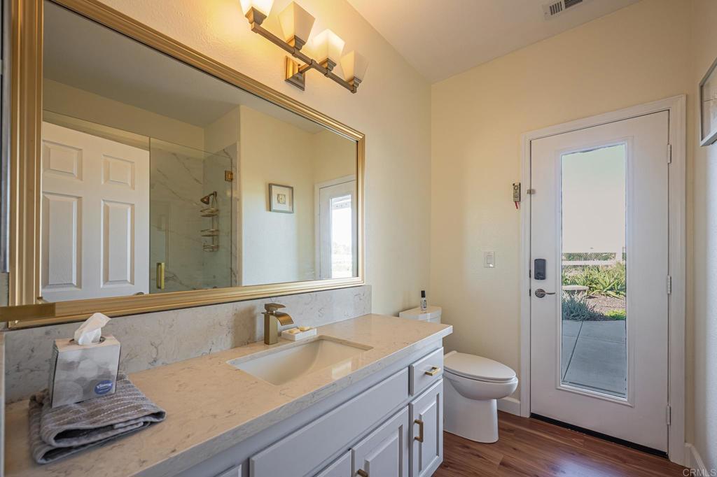 30606 Falling Star Circle Valley Center, CA 92082 - Photo 23 of 70 a bathroom with a granite countertop sink toilet and shower