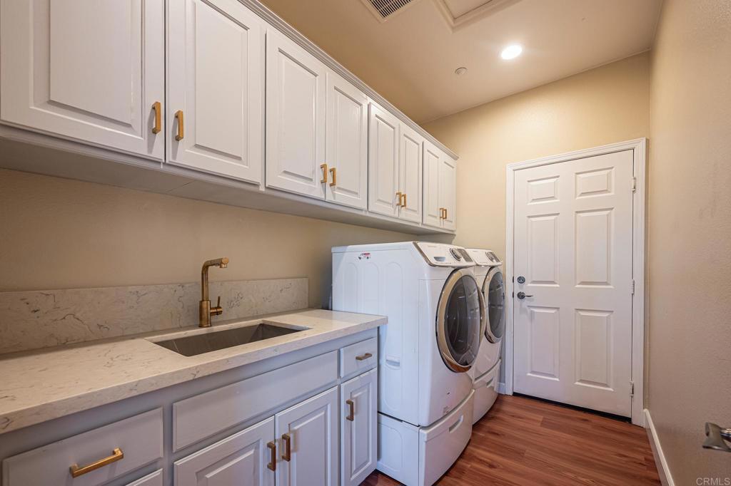 30606 Falling Star Circle Valley Center, CA 92082 - Photo 44 of 70 a utility room with sink dryer and washer