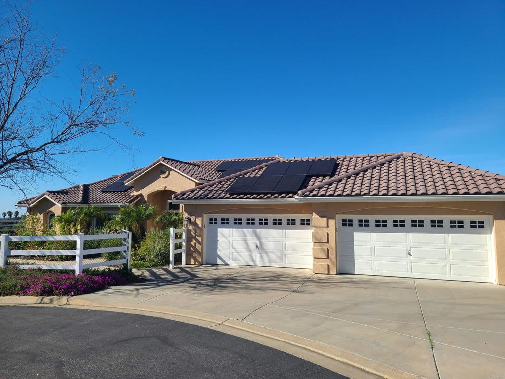 30606 Falling Star Circle Valley Center, CA 92082 - Photo 70 of 70 a front view of a house with a garden and garage