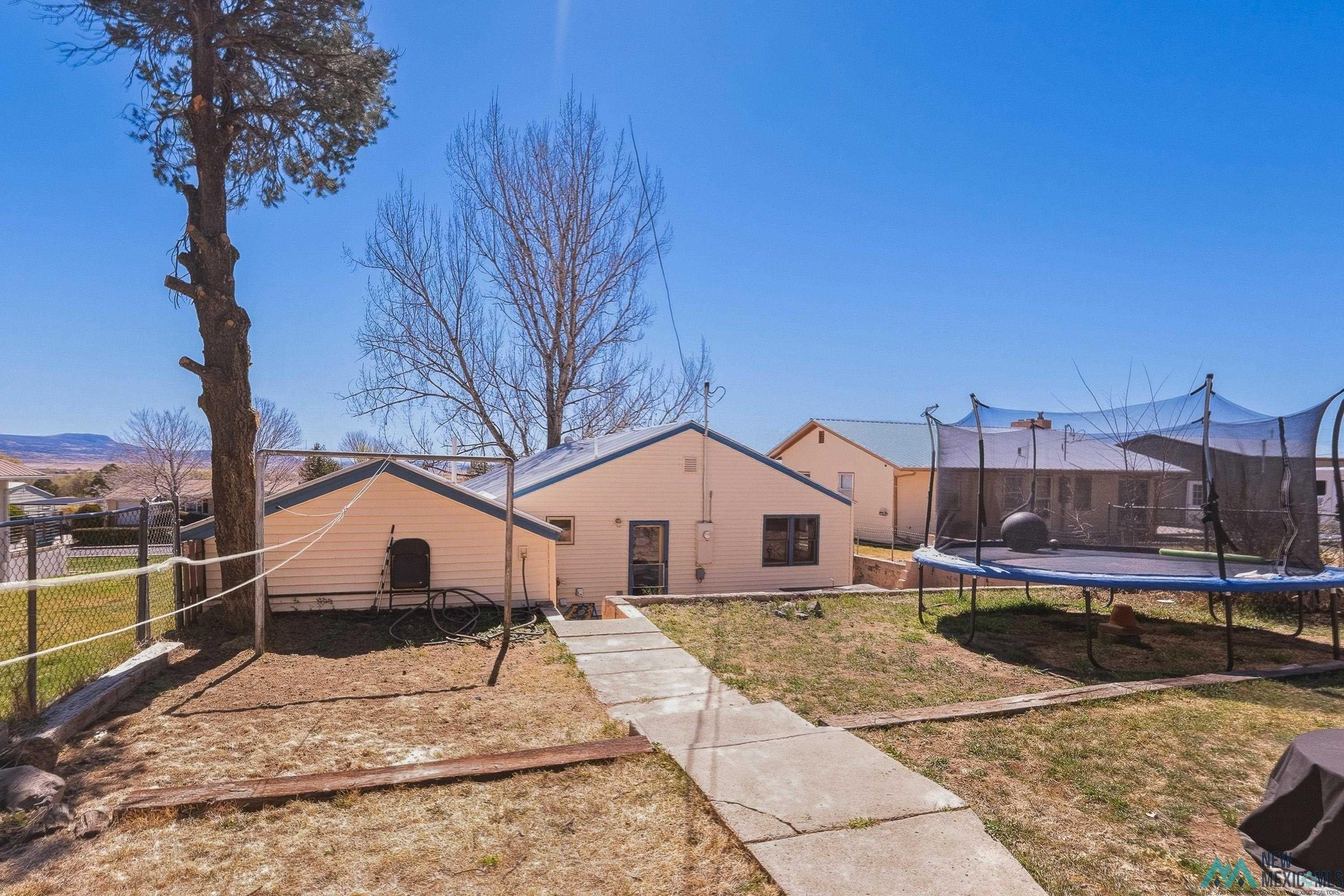 1432 South 5th Street Raton, NM 87740 - Photo 24 of 32 Rear view of property with a trampoline