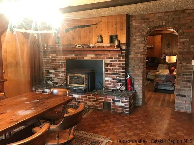 102 Valenti Road Gilboa, NY 12076 - Photo 11 of 32 a living room with furniture a fireplace and a table