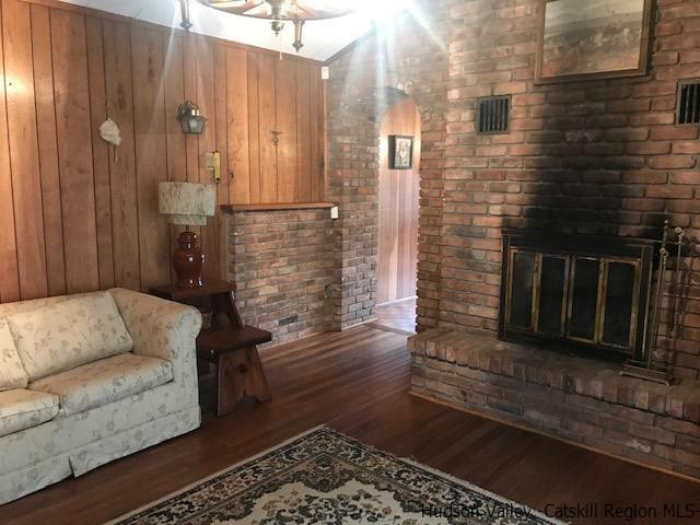 102 Valenti Road Gilboa, NY 12076 - Photo 19 of 32 a living room with furniture wooden floor and a fireplace