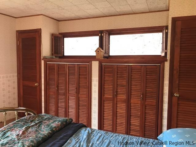 102 Valenti Road Gilboa, NY 12076 - Photo 21 of 32 a bedroom with a bed and a window