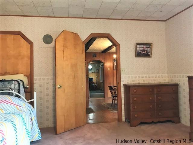 102 Valenti Road Gilboa, NY 12076 - Photo 22 of 32 a bedroom with a bed and a mirror