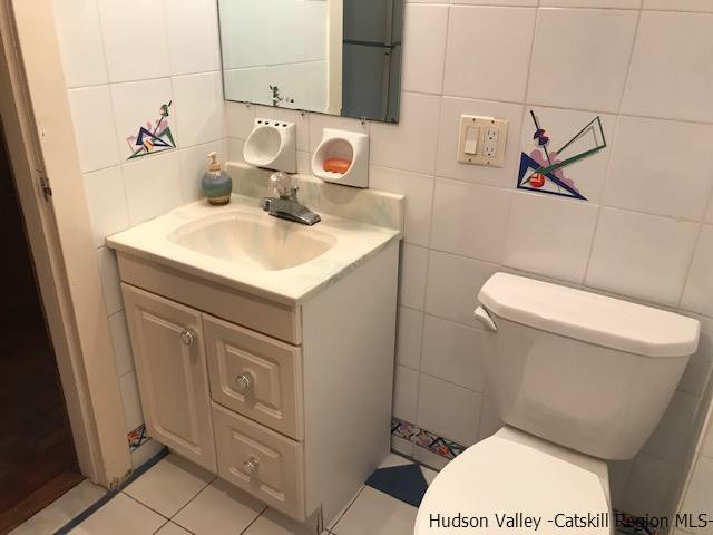 102 Valenti Road Gilboa, NY 12076 - Photo 23 of 32 a bathroom with a sink a toilet and a mirror