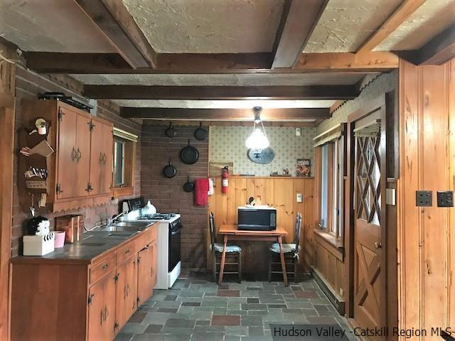 102 Valenti Road Gilboa, NY 12076 - Photo 3 of 32 a kitchen with table chairs refrigerator and cabinets