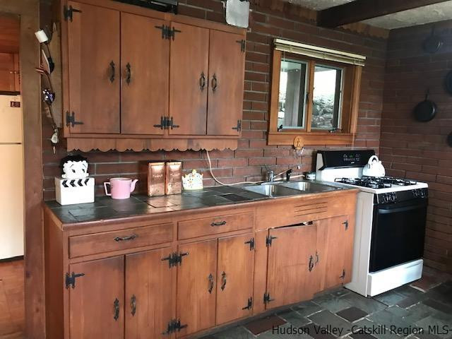 102 Valenti Road Gilboa, NY 12076 - Photo 4 of 32 a kitchen with granite countertop a sink and cabinets