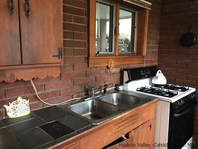 102 Valenti Road Gilboa, NY 12076 - Photo 5 of 32 a kitchen that has a sink and a stove