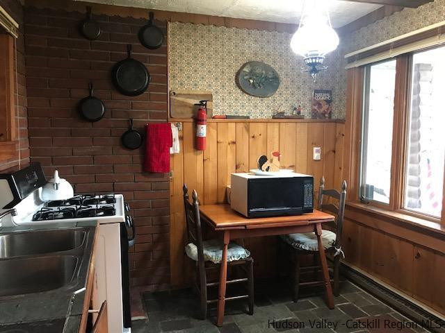 102 Valenti Road Gilboa, NY 12076 - Photo 6 of 32 a kitchen with a stove and a table