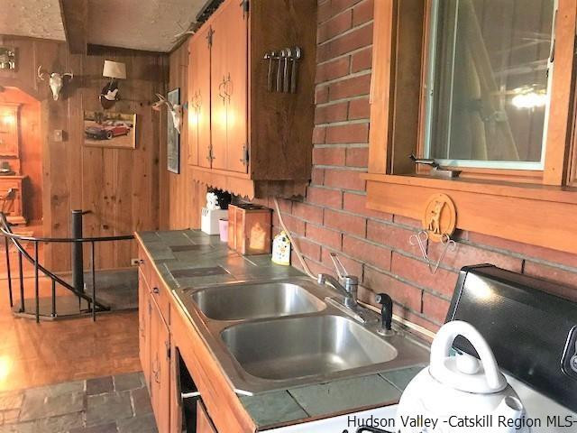 102 Valenti Road Gilboa, NY 12076 - Photo 9 of 32 a kitchen with a sink and a large mirror