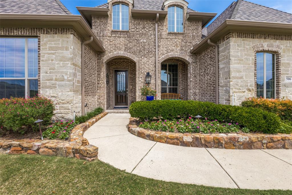 506 Life Spring Drive Rockwall, TX 75087 - Photo 3 of 36 a front view of a house with potted plants