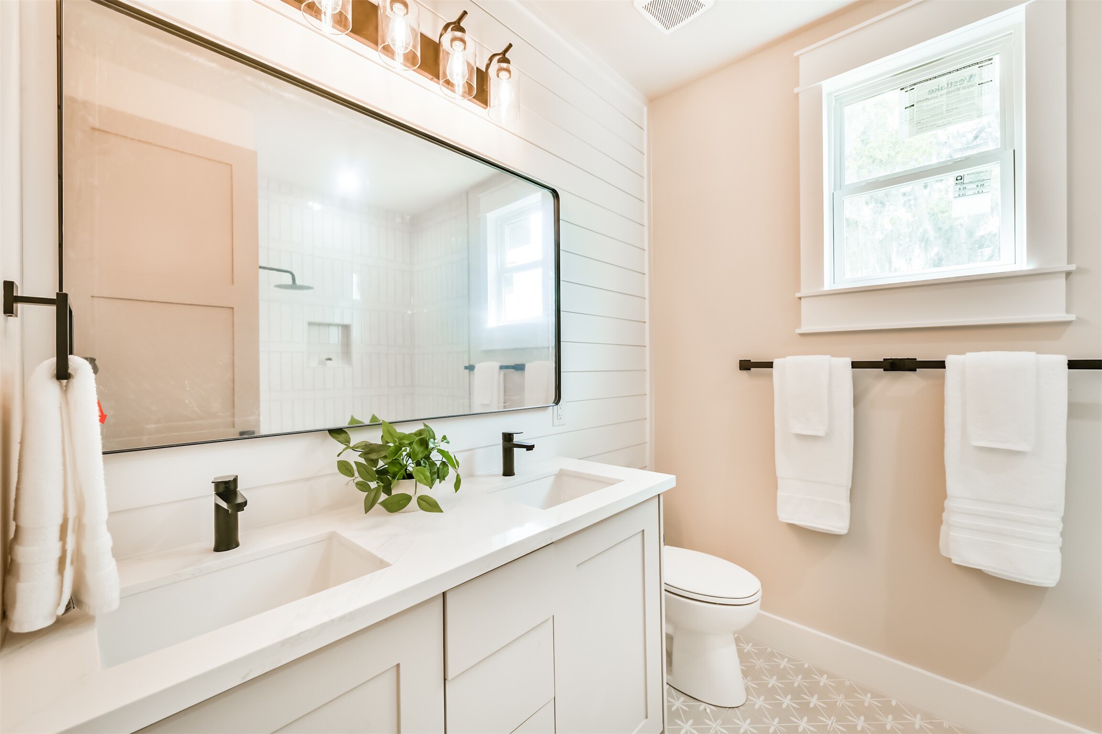 250 Pony Trail Angleton, TX 77515 - Photo 19 of 32 This modern full bathroom features elegant fixtures, dual sinks, and abundant natural light for a refreshing and stylish space.