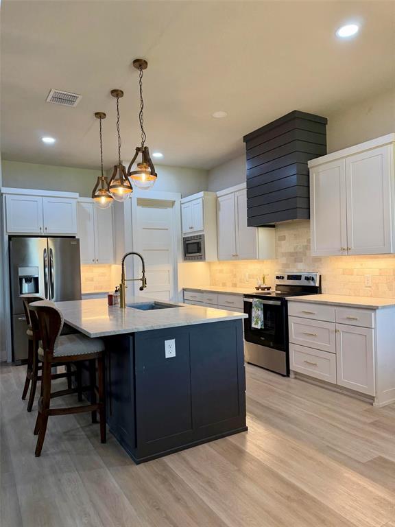 151 Gopher Road Weatherford, TX 76088 - Photo 5 of 22 a kitchen with a sink cabinets and wooden floor