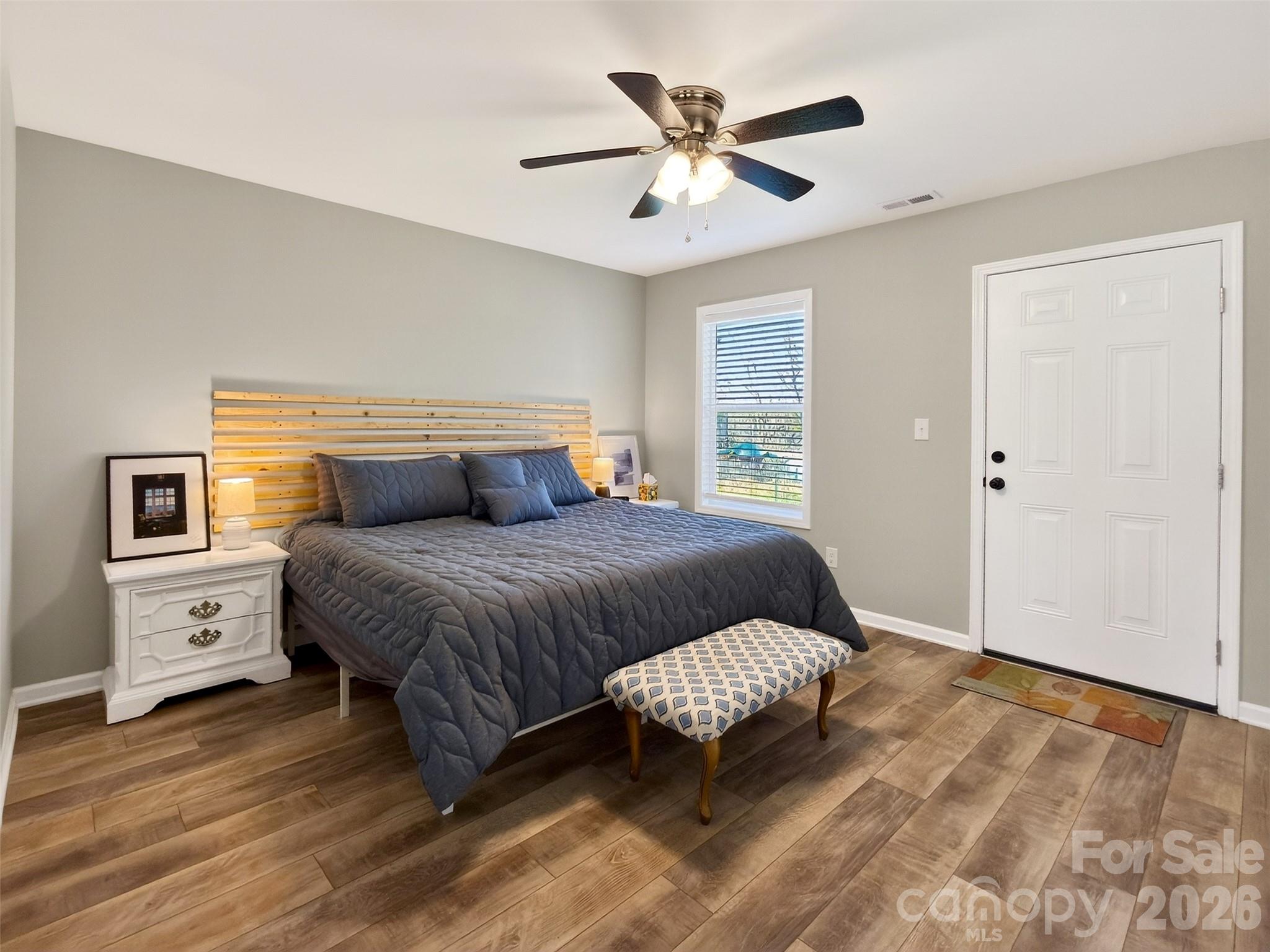 116 Bostic Street Marion, NC 28752 - Photo 14 of 28 a bedroom with a large bed and a ceiling fan