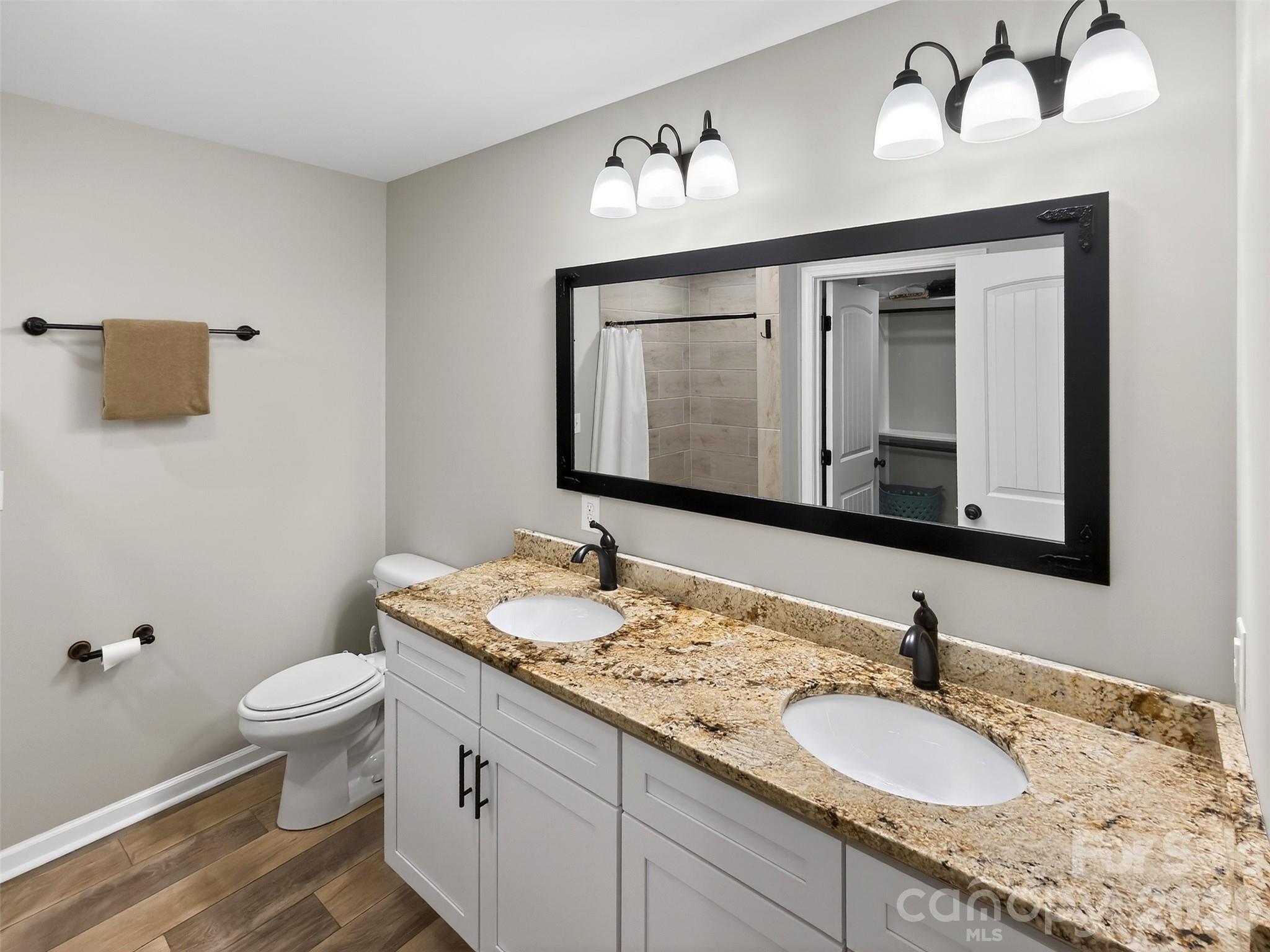 116 Bostic Street Marion, NC 28752 - Photo 17 of 28 a bathroom with a granite countertop sink and a mirror