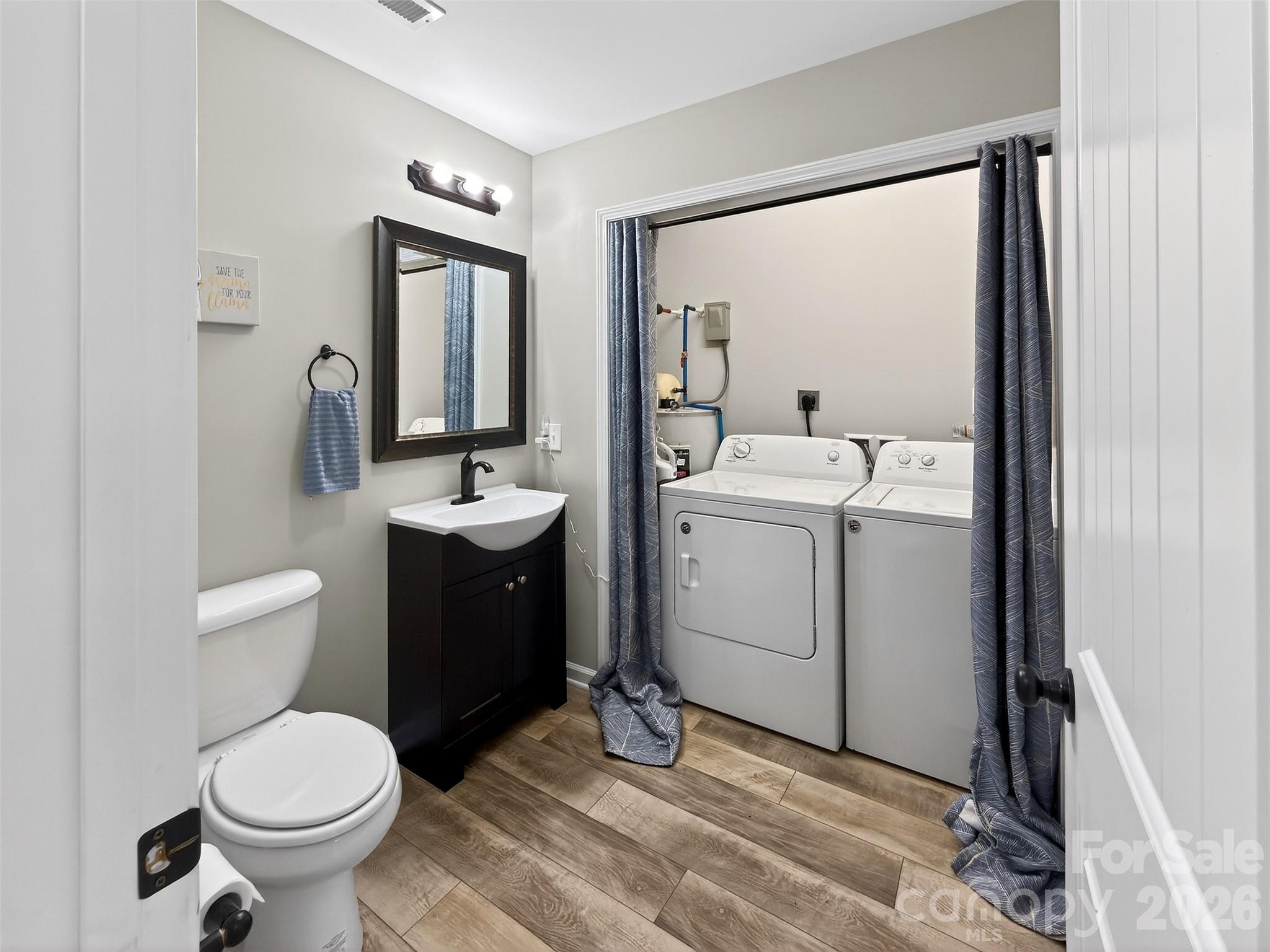 116 Bostic Street Marion, NC 28752 - Photo 20 of 28 a bathroom with a toilet sink and mirror