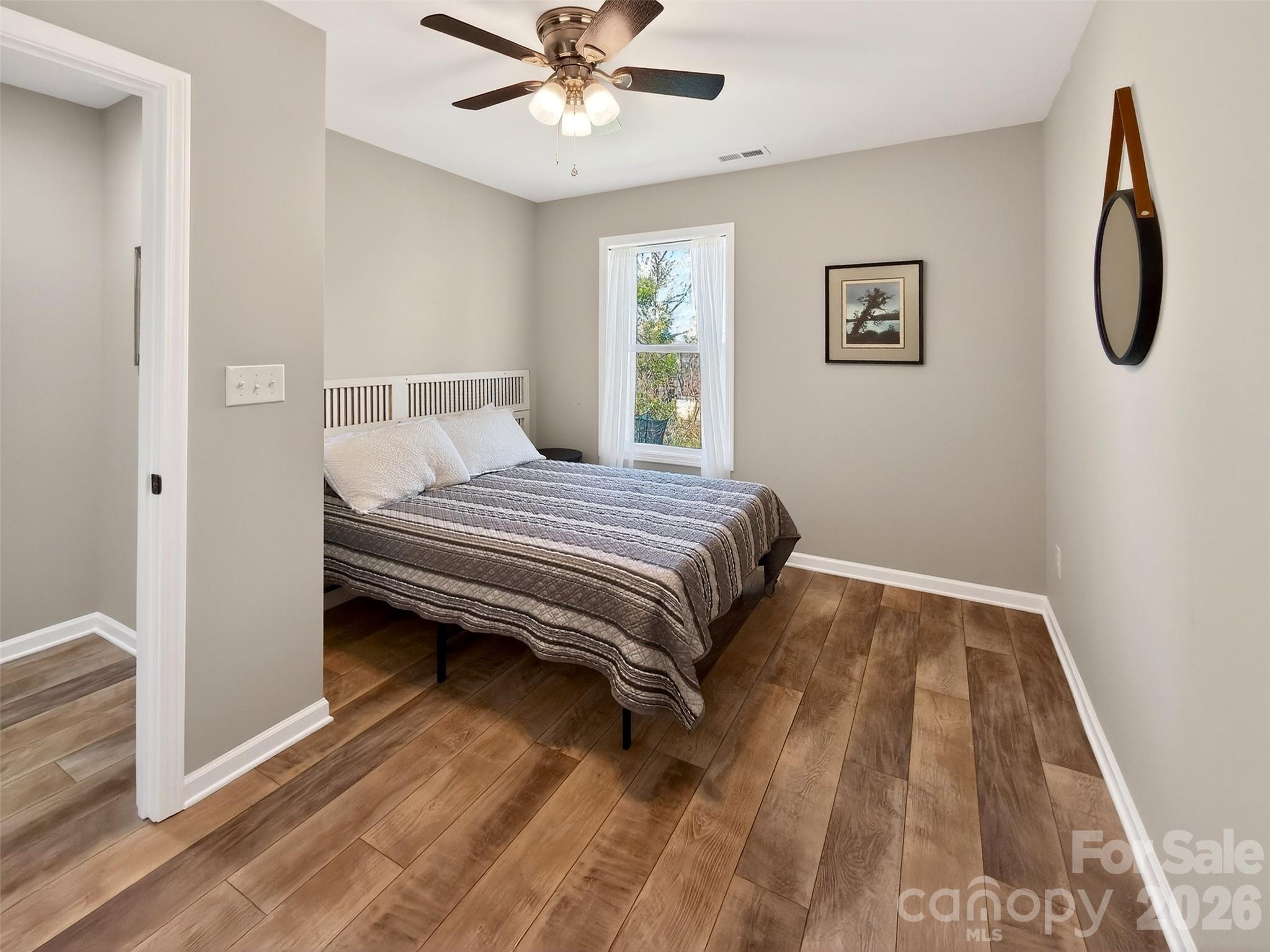 116 Bostic Street Marion, NC 28752 - Photo 23 of 28 a bedroom with a bed and a chandelier