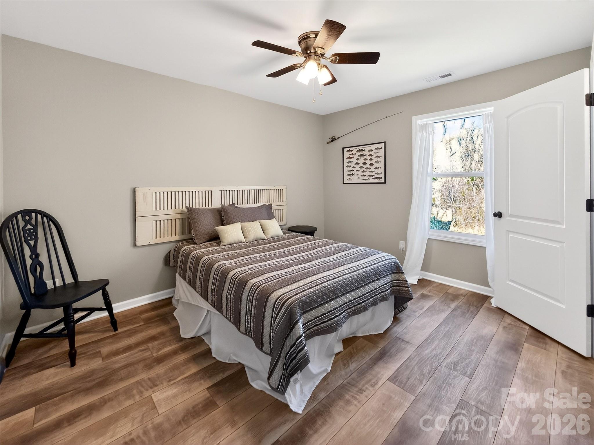 116 Bostic Street Marion, NC 28752 - Photo 25 of 28 a bedroom with a bed and a chair