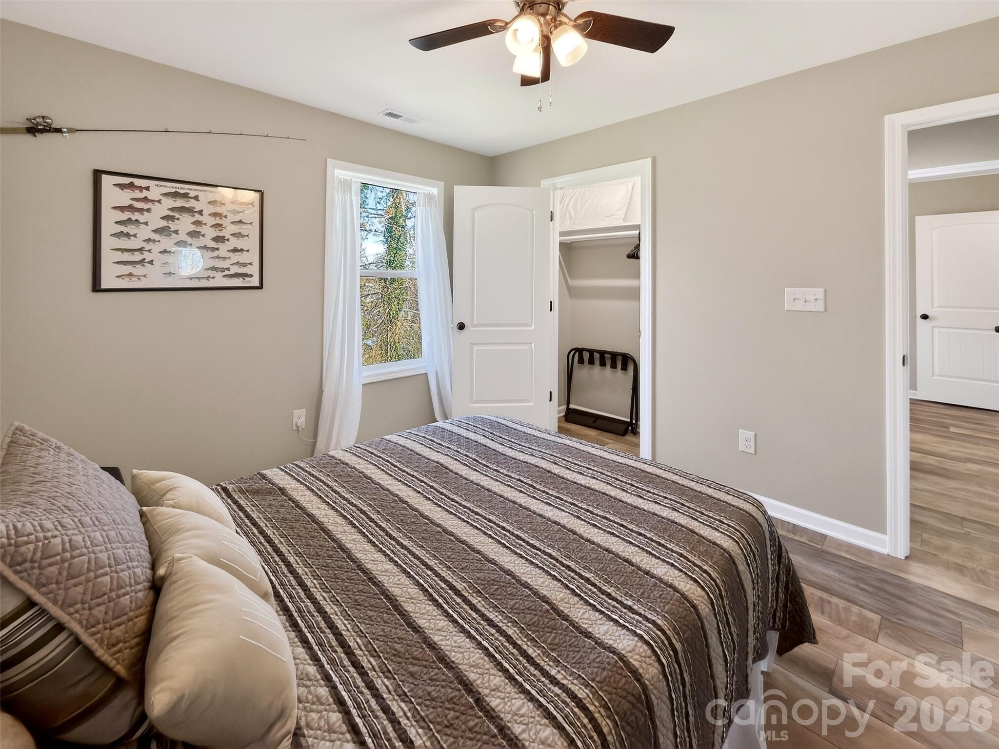 116 Bostic Street Marion, NC 28752 - Photo 26 of 28 a bedroom with a bed and a chandelier