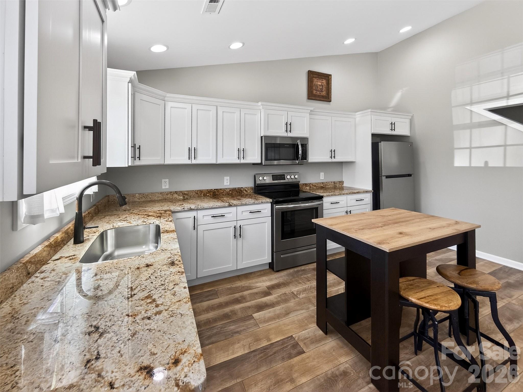 116 Bostic Street Marion, NC 28752 - Photo 5 of 28 a kitchen that has a sink and a stove in it