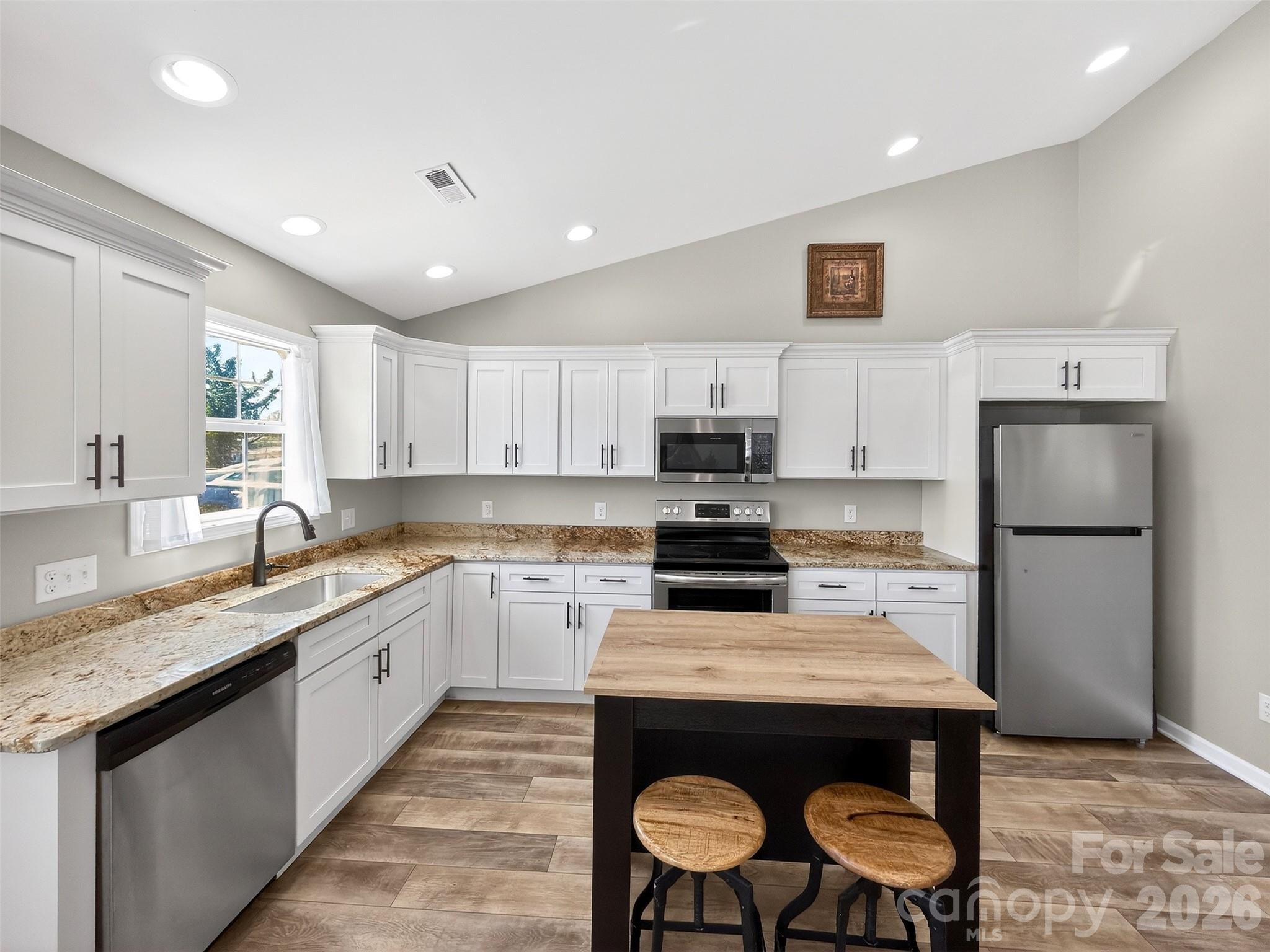 116 Bostic Street Marion, NC 28752 - Photo 6 of 28 a kitchen with a sink a stove a refrigerator cabinets and a dining table