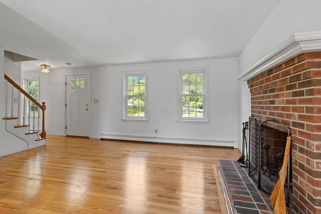 10 Farm Road Stow, MA 01775 - Photo 12 of 37 a view of an empty room with wooden floor and a window