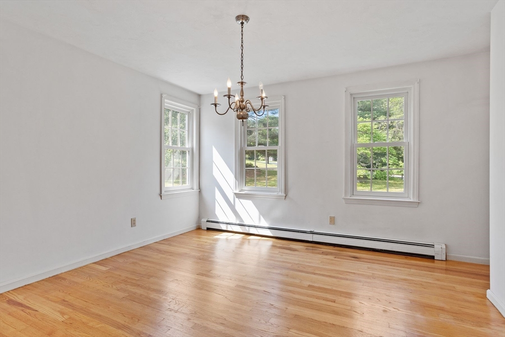 10 Farm Road Stow, MA 01775 - Photo 16 of 37 a view of an empty room with wooden floor and a window