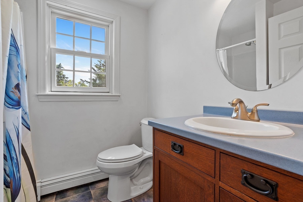 10 Farm Road Stow, MA 01775 - Photo 17 of 37 a bathroom with a toilet a sink a vanity and mirror