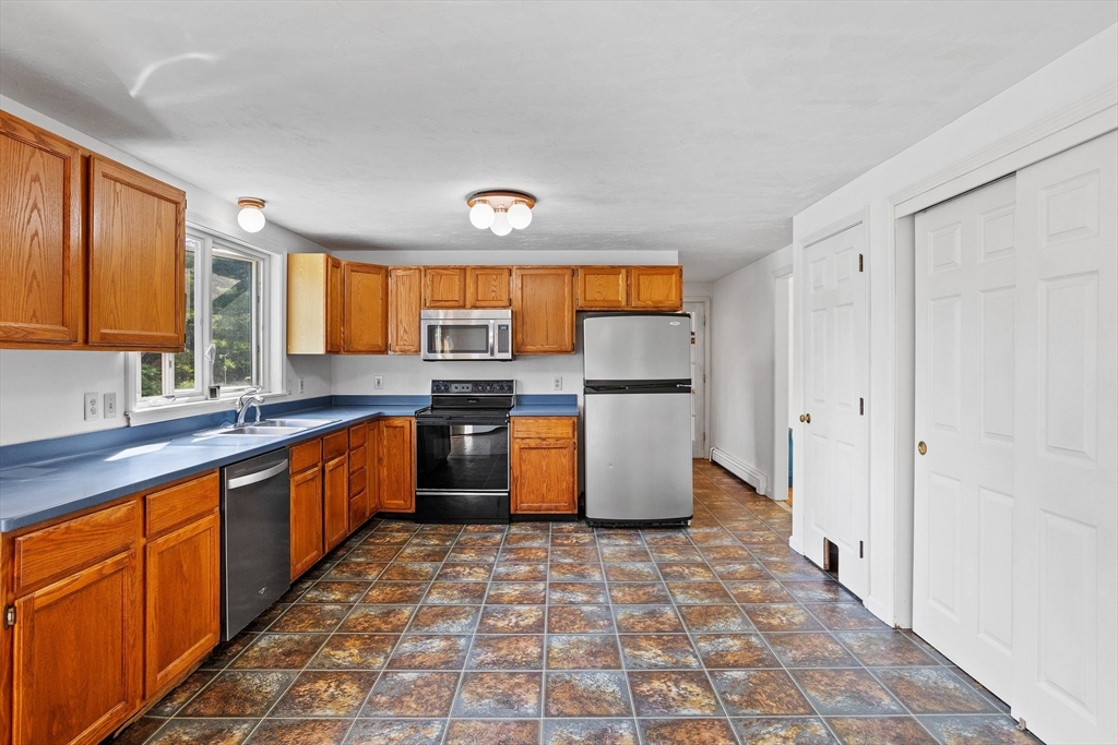 10 Farm Road Stow, MA 01775 - Photo 2 of 37 a large kitchen with stainless steel appliances granite countertop a stove a sink dishwasher and a refrigerator