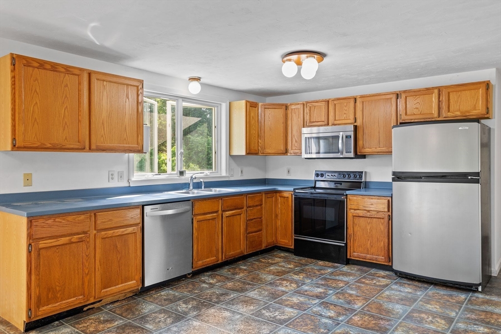 10 Farm Road Stow, MA 01775 - Photo 3 of 37 a kitchen with stainless steel appliances granite countertop a refrigerator sink and cabinets